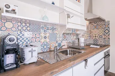 a kitchen with a sink and tiles on the wall at LovelyStay - Sweet Escape II - Backyard in Quarteira