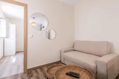 a living room with a couch and a table at LovelyStay - Sweet Escape II - Backyard in Quarteira