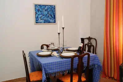 a dining room table with a blue table cloth and chairs at Rossio in Albufeira