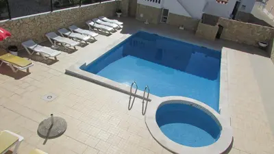 an overhead view of a swimming pool with lounge chairs at Apartamento - 2 a 4 Pessoas- Piscina in Olhos de Água