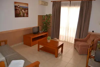 a living room with a couch and a tv at Apartamento - 2 a 4 Pessoas- Piscina in Olhos de Água
