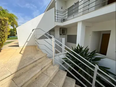 two beds in a room with a window at Albufeira Lux Apartment in Albufeira
