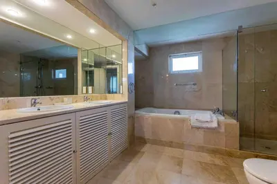 a bathroom with a tub and a sink and a toilet at Luxury Villa 6 bedrooms with private pool in Vilamoura