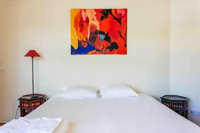 a bedroom with two beds and a painting on the wall at Luxury Villa 6 bedrooms with private pool in Vilamoura