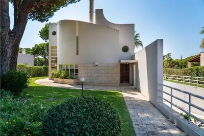 a white house with a tree and a fence at Luxury Villa 6 bedrooms with private pool in Vilamoura