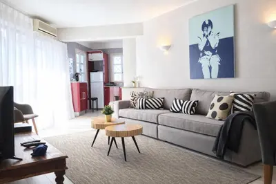 a living room with a gray couch with pillows at Stylish Center Apartment Vilamoura in Vilamoura