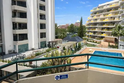 a view of the pool from the balcony of a apartment at Stylish Center Apartment Vilamoura in Vilamoura