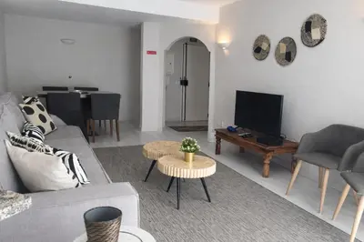 a living room with a couch and a tv and a table at Stylish Center Apartment Vilamoura in Vilamoura