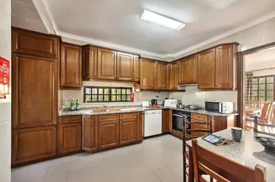 a patio with a white table and chairs at Spacious 4 bedroom villa, private pool, free air conditioning and wifi in Quarteira