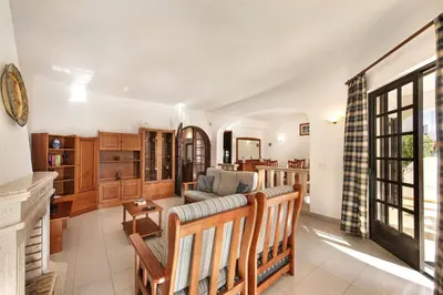 a dining room with a table and chairs at Spacious 4 bedroom villa, private pool, free air conditioning and wifi in Quarteira