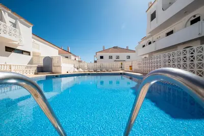 a large swimming pool in front of a building at #007 Foxy W by Home Holidays in Albufeira