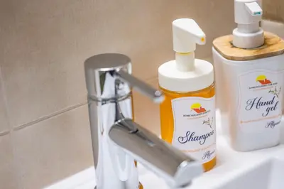 a bathroom sink with a bottle of mouthwash and a faucet at #006 Foxy D by Home Holidays in Albufeira