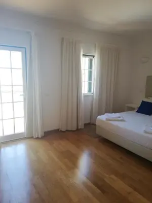 a bedroom with a bed and a large window at Villa V2 X in Albufeira