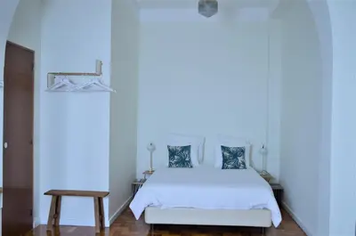 a bedroom with a white bed with blue walls at Casa aOrta Downtown in Faro