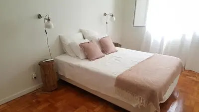 a bedroom with a bed with pink and white pillows at Casa aOrta Downtown in Faro