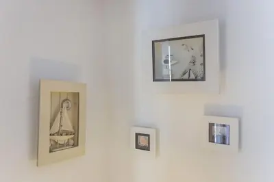 a group of pictures on a white wall at 1Bed Apart Quinta do Lago in Almancil