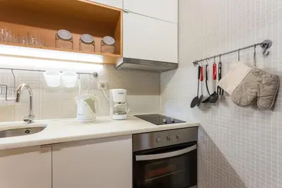 a small kitchen with a sink and a stove at 1Bed Apart Quinta do Lago in Almancil