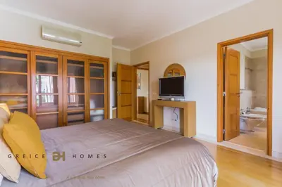 a bedroom with a bed and a tv and a bathroom at GREICE HOMES 2 BEDROOM LUXURY APARTMENT VICTORIA BOULEVARD in Vilamoura