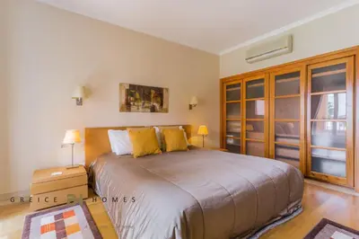 a bedroom with a large bed with yellow pillows at GREICE HOMES 2 BEDROOM LUXURY APARTMENT VICTORIA BOULEVARD in Vilamoura