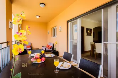 a dining room with a table with fruit and wine glasses at GREICE HOMES 2 BEDROOM LUXURY APARTMENT VICTORIA BOULEVARD in Vilamoura