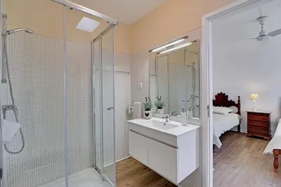 a bathroom with a sink and a glass shower at Vilamoura Golf Villa 1 With Pool by Homing in Vilamoura