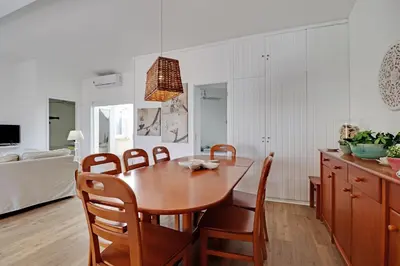 a kitchen and dining room with a wooden table and chairs at Vilamoura Golf Villa 1 With Pool by Homing in Vilamoura