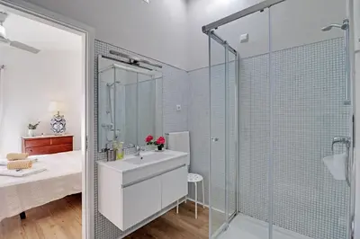 a bathroom with a sink and a glass shower at Vilamoura Golf Villa 1 With Pool by Homing in Vilamoura
