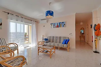 a living room with a couch and a table at Albufeira Concept 1 with Pool by Homing in Guia