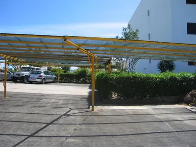 a parking lot with a large metal structure at Sol Nascente Garden in Vilamoura
