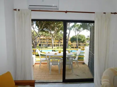 a kitchen with a sink and a washing machine at Sol Nascente Garden in Vilamoura
