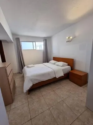 a bedroom with a large bed and a window at AAA Awesome Apartamentos Albufeira in Albufeira