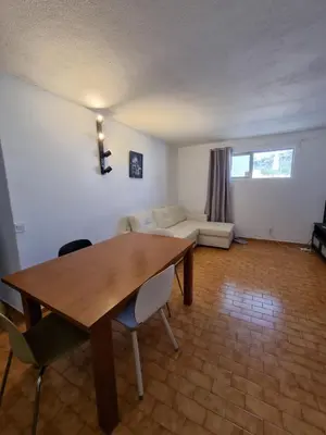 a living room with a table and a couch at AAA Awesome Apartamentos Albufeira in Albufeira
