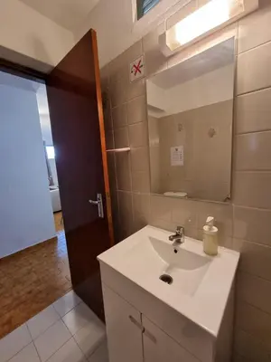 a bathroom with a sink and a mirror at AAA Awesome Apartamentos Albufeira in Albufeira
