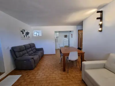 a living room with a couch and a table at AAA Awesome Apartamentos Albufeira in Albufeira