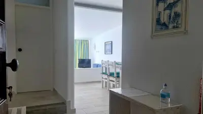 a hallway with a room with a table and chairs at Albufeira, with terrace, see views, 5 min to beach (21) in Albufeira