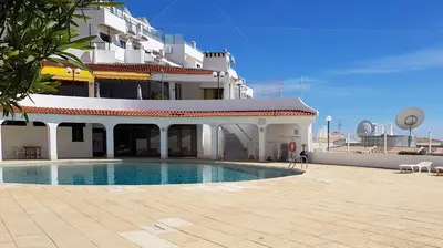 a building with a swimming pool in front of a building at Albufeira, with terrace, see views, 5 min to beach (21) in Albufeira