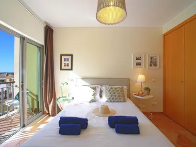 a bedroom with a large bed with a large window at Apartment Vilas Mouriscas by Interhome in Vilamoura