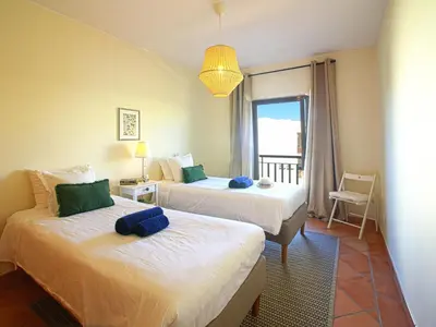 a hotel room with two beds and a window at Apartment Vilas Mouriscas by Interhome in Vilamoura