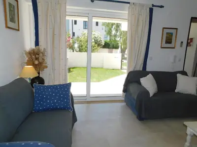 a dining room with a white table and chairs at Estrela Mar Marina Villa in Quarteira