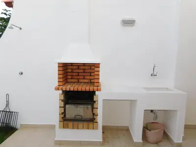 a bathroom with a sink and a glass shower at Estrela Mar Marina Villa in Quarteira