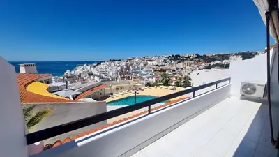 a balcony with a view of a city and the ocean at Albufeira, One step to the beach (13) in Albufeira