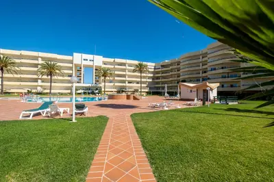 a large apartment building with a pool and a lawn at VR Galé Mar in Albufeira