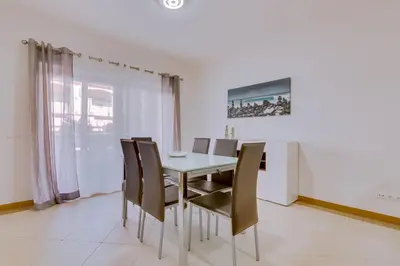 a dining room with a table and chairs at Victoria Boulevard - Vasco da Gama - Vilamoura in Vilamoura
