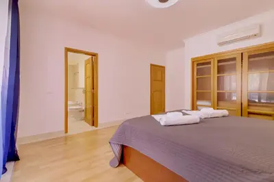 a bedroom with a bed with two towels on it at Victoria Boulevard - Vasco da Gama - Vilamoura in Vilamoura