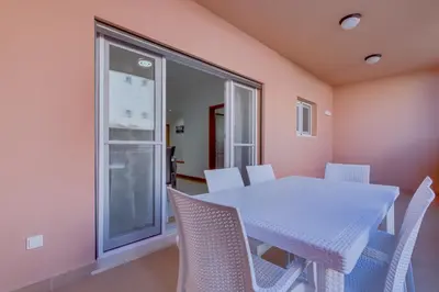 a dining room with a white table and chairs at Victoria Boulevard - Vasco da Gama - Vilamoura in Vilamoura