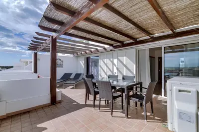 a patio with a table and chairs on a balcony at Primula - Wonderful view - Vilamoura Marina in Vilamoura