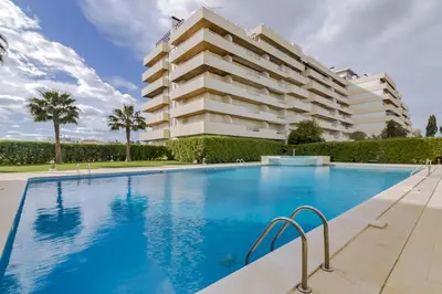 a swimming pool in front of a building at Primula - Wonderful view - Vilamoura Marina in Vilamoura
