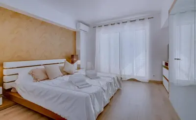 a white bedroom with a large bed and a window at Primula - Wonderful view - Vilamoura Marina in Vilamoura