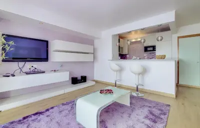 a living room with a tv and a purple rug at Primula - Wonderful view - Vilamoura Marina in Vilamoura