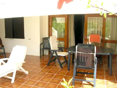 a dining room with white chairs and a table at Welcoming House in Albufeira in Albufeira